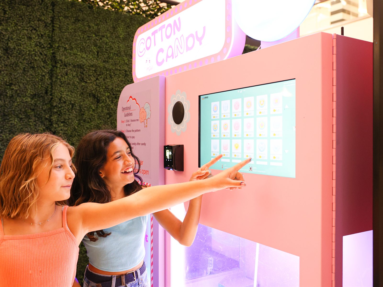 Bloomjoy robotic cotton candy machine in a colorful public setting